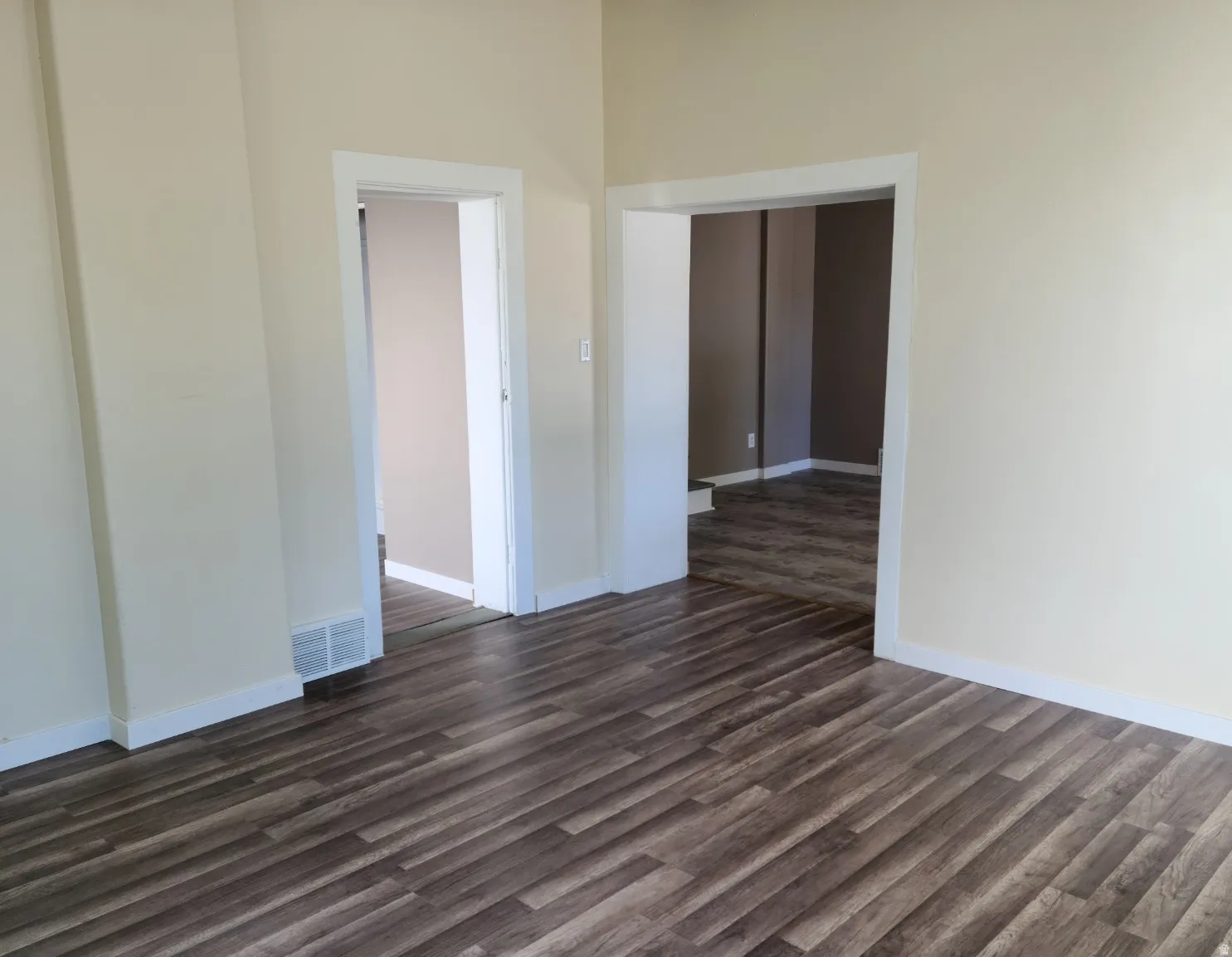 Wood-finish flooring throughout, light-toned wall paint, and white trim