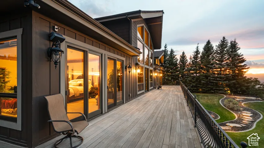 1500 ft wrap-around lifetime African hardwood deck, classic serpentine railing, and exterior wall lanterns