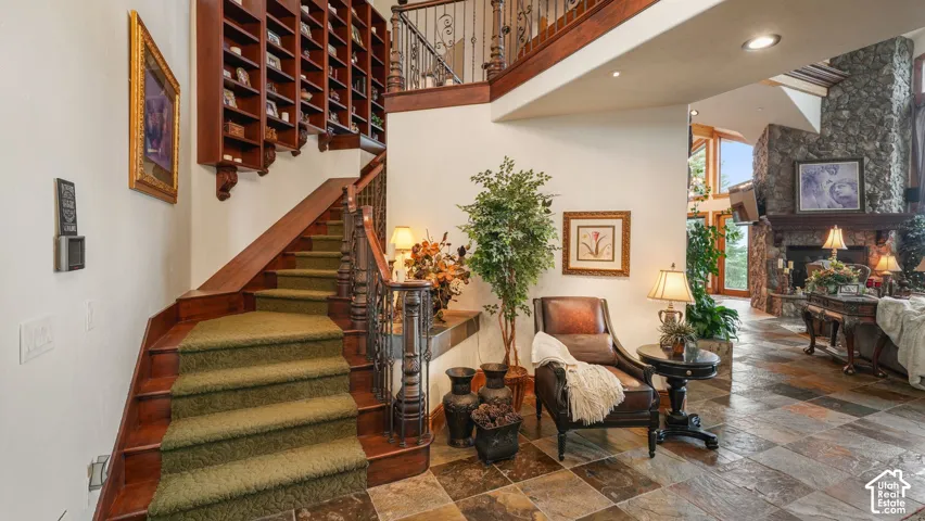 Custom forged iron balustrade and distinct hand-made millwork shelving