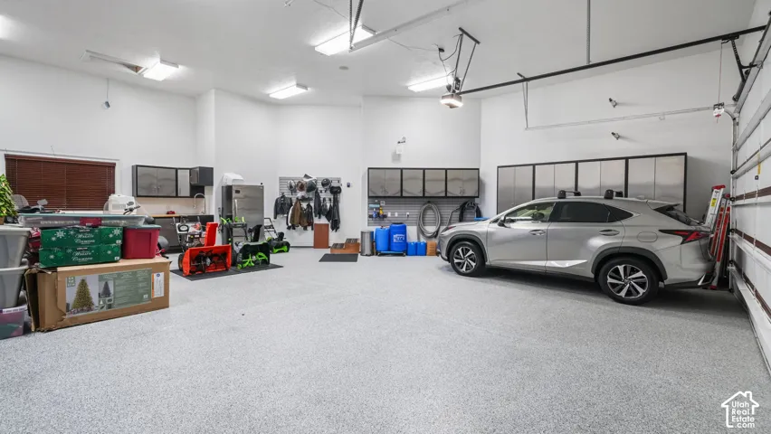 15ft ceiling RV garage with built-in stainless steel storage cabinets and new epoxy flooring