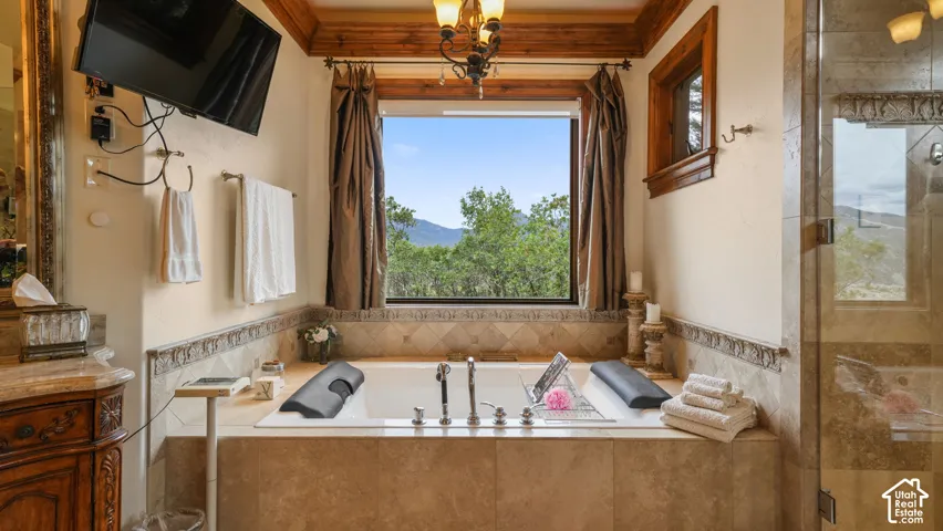 Soaking tub with views and stone/wood surround