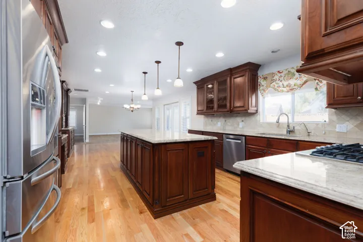 Kitchen featuring hardwood flooring, recessed lighting, and stainless steel appliances