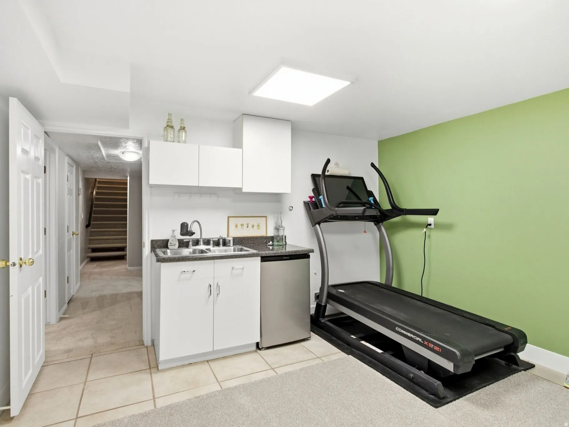 Flex room with utility sink and mini refrigerator