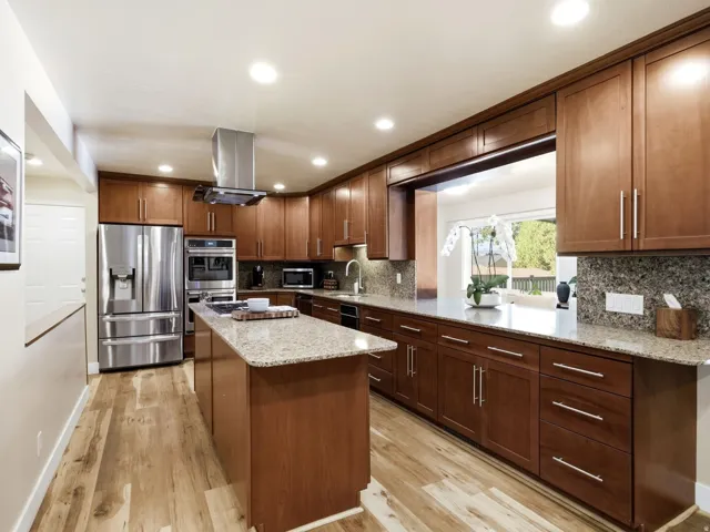 Granite counters, gas range, brand new GE Cafe double ovens and GE dishwasher.