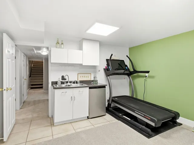 Flex room with utility sink and mini refrigerator
