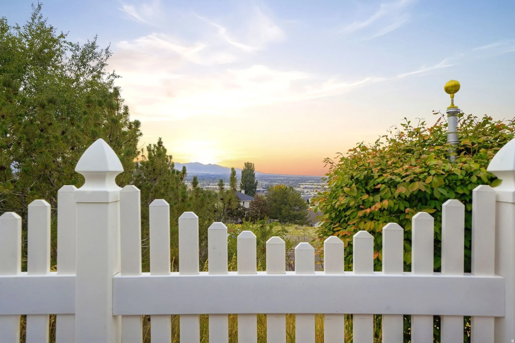 White picket fence with decorative finials