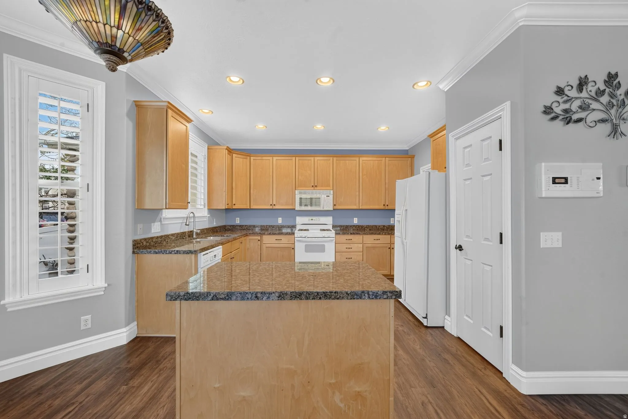 Kitchen featuring wood-finish flooring, recessed lighting, and a center island with a granite countertop