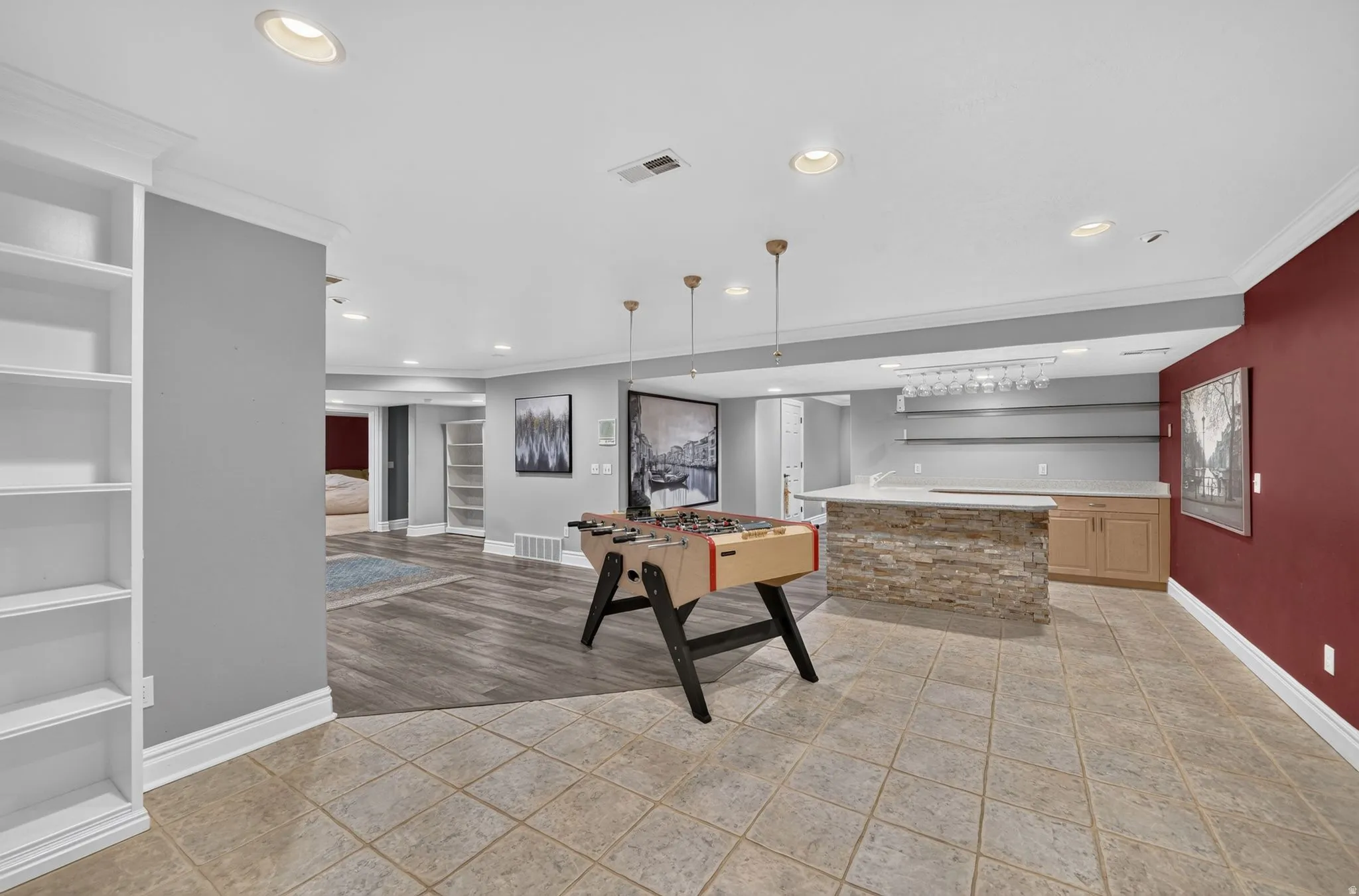 Recessed lighting, built-in shelving, wood-finish flooring, tile flooring, and a stone-clad bar with shelving