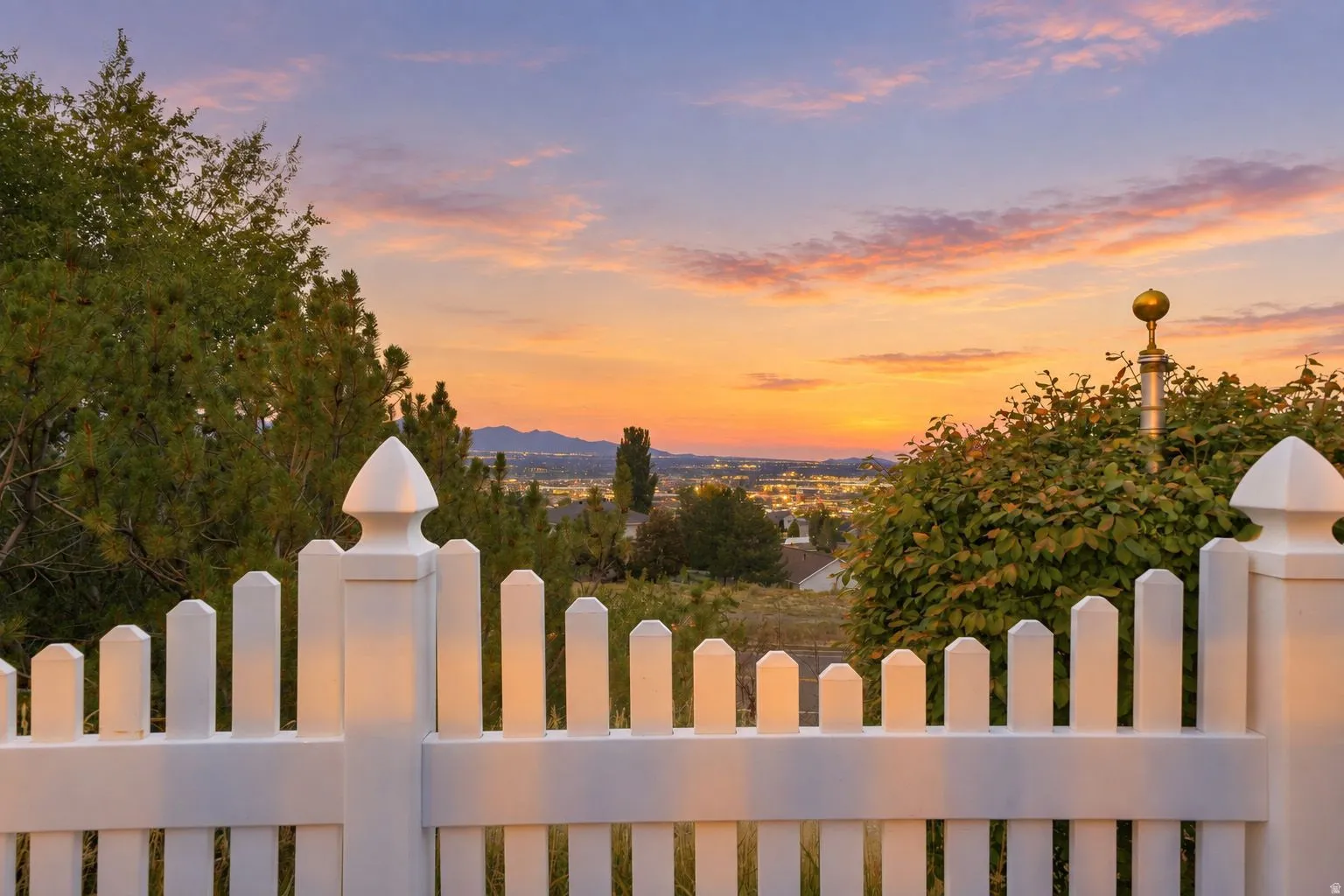 White picket fence with decorative finials