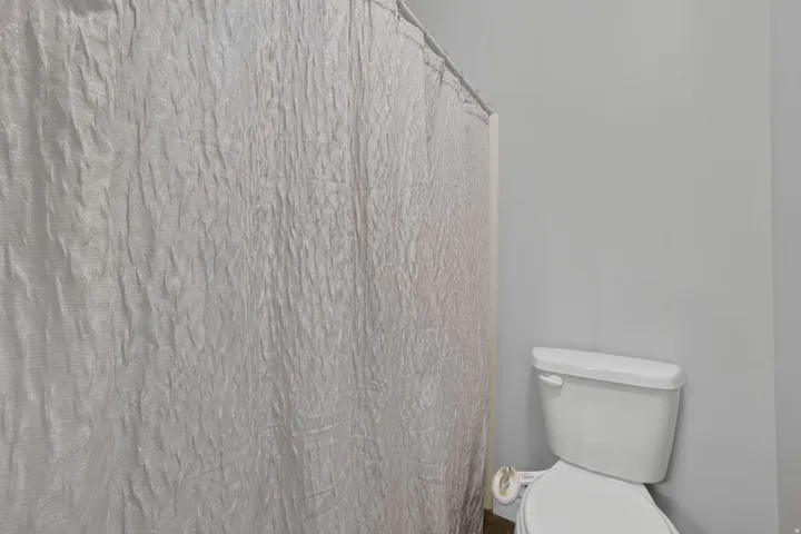 White toilet with a toilet paper holder