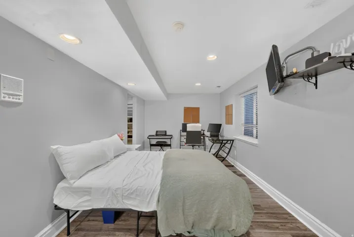 Recessed lighting, wood-finish flooring, and crisp white trim
