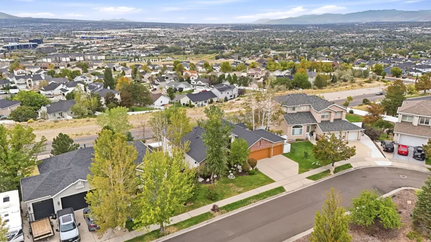 Residential neighborhood setting with mature trees and paved streets