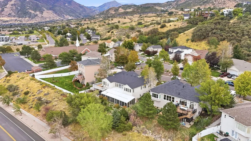 Residential property with a multi-level exterior, an enclosed patio, and a backyard area