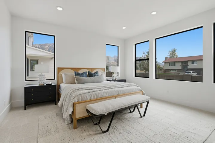 Primary Suite with recessed lighting and multiple black-framed windows