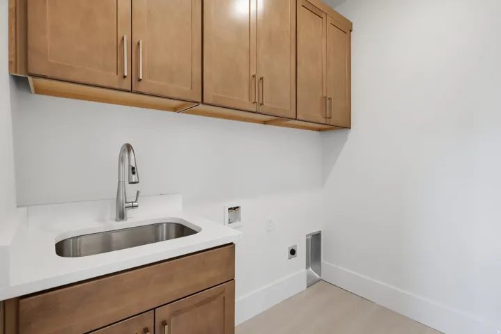 Upper and lower cabinetry with integrated sink, and pull-down faucet