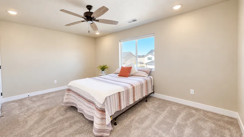 Neutral-toned walls with recessed lighting, ceiling fan, and window