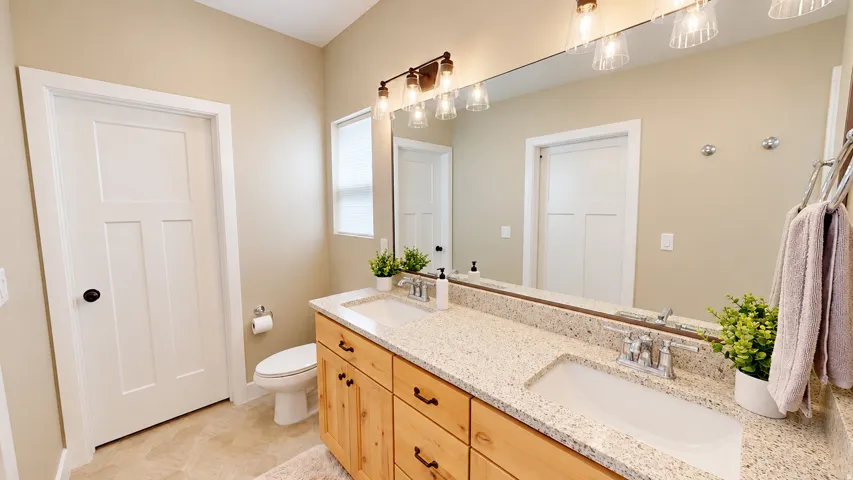 Double vanity with integrated sinks and a stone-finish countertop