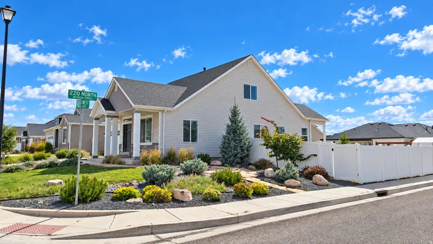 Inviting exterior with light-colored siding and dark shingle roofing