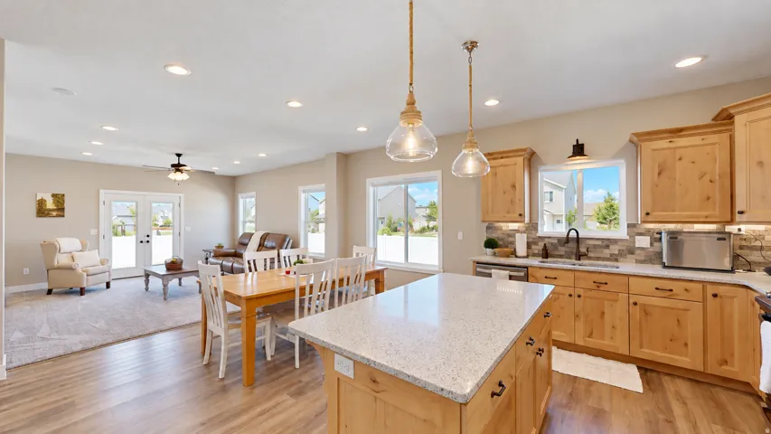 Open-concept living space featuring wood-finish flooring, recessed lighting, and french doors