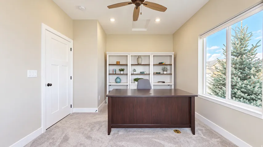 Recessed lighting, ceiling fan, built-in shelving, and large window