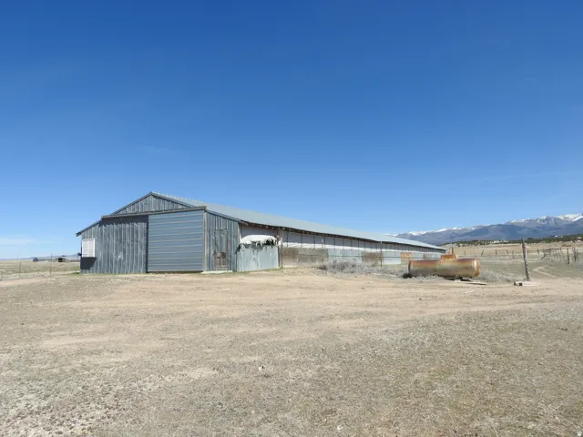 Long metal-sided barn with a gabled roof