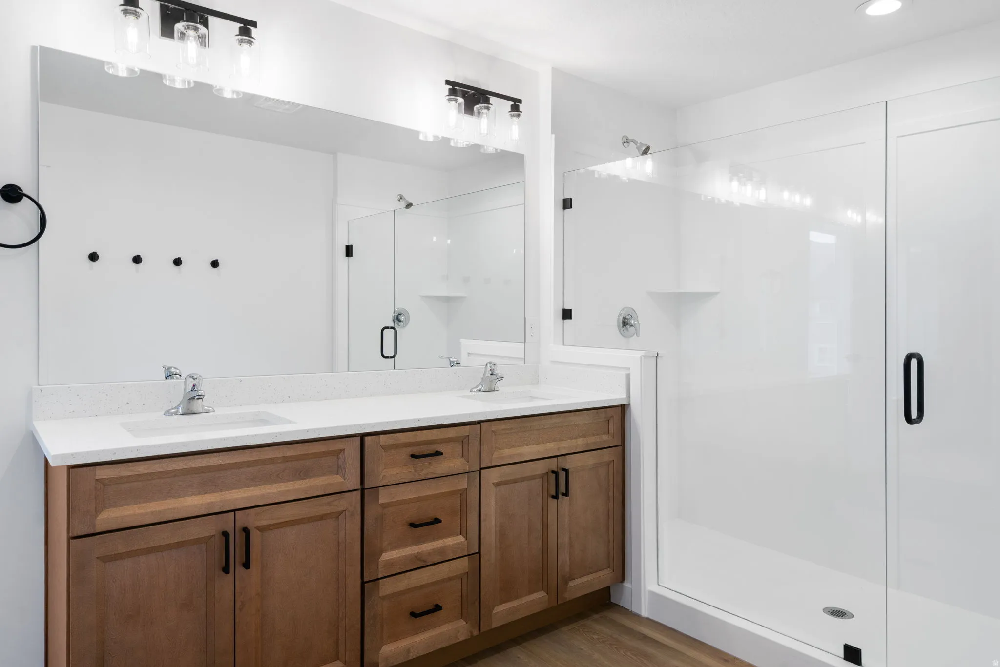 Double vanity with integrated sinks and white countertops