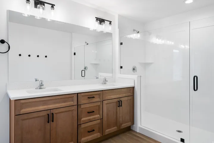 Double vanity with integrated sinks and white countertops