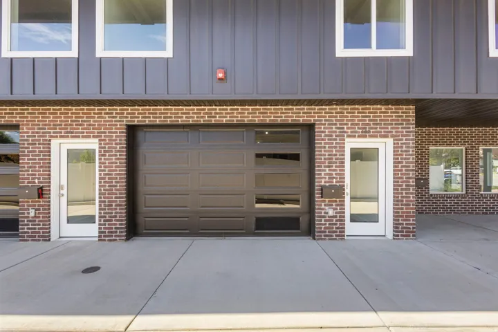 Brick facade with vertical panel siding