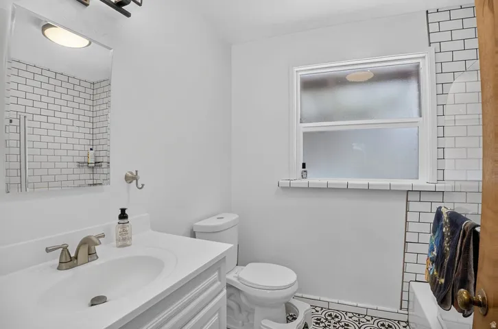 White vanity with an integrated sink and brushed nickel faucet