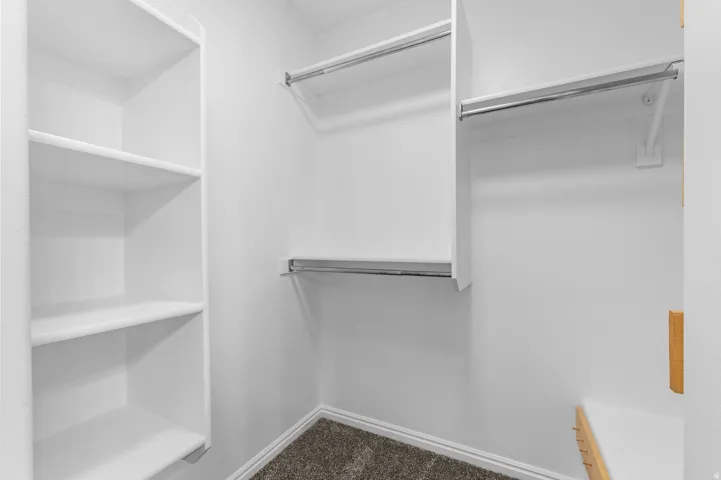 White shelving system featuring multiple shelves and hanging rods