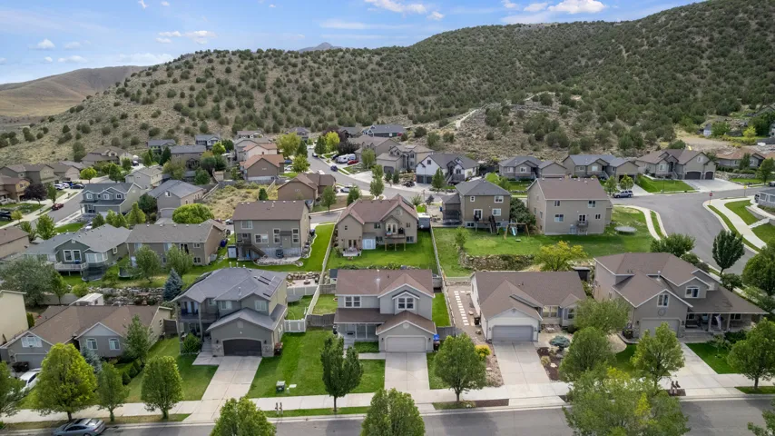 Residential properties with varied architectural styles, paved roadways, and landscaped yards