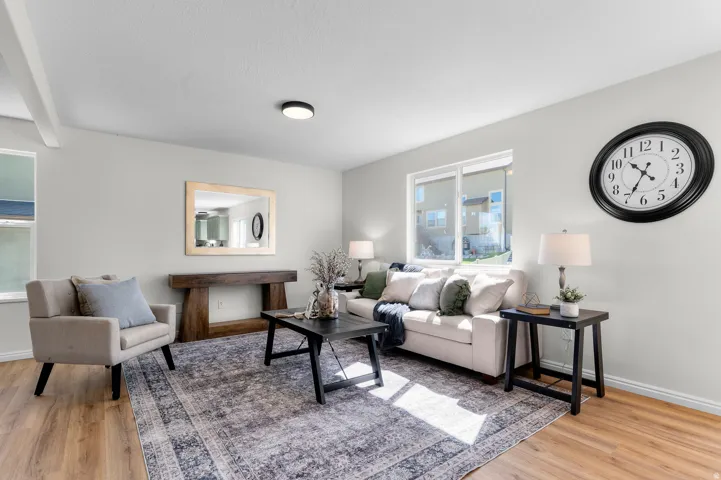 Wood-finish flooring, white walls, and a recessed window