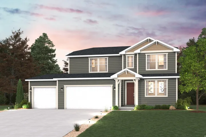 Two-story residence featuring a dark gray siding exterior, multiple gables with cedar shake accents, a covered front entry, and a two-car garage with an additional single-car garage