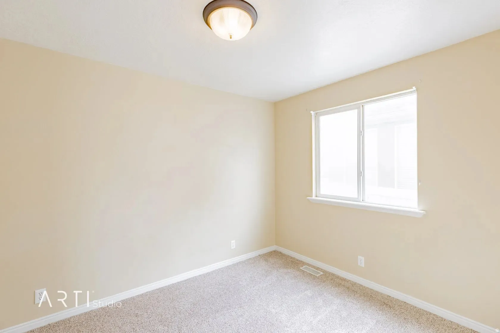 Neutral wall color, carpeted flooring, and a single window with white trim