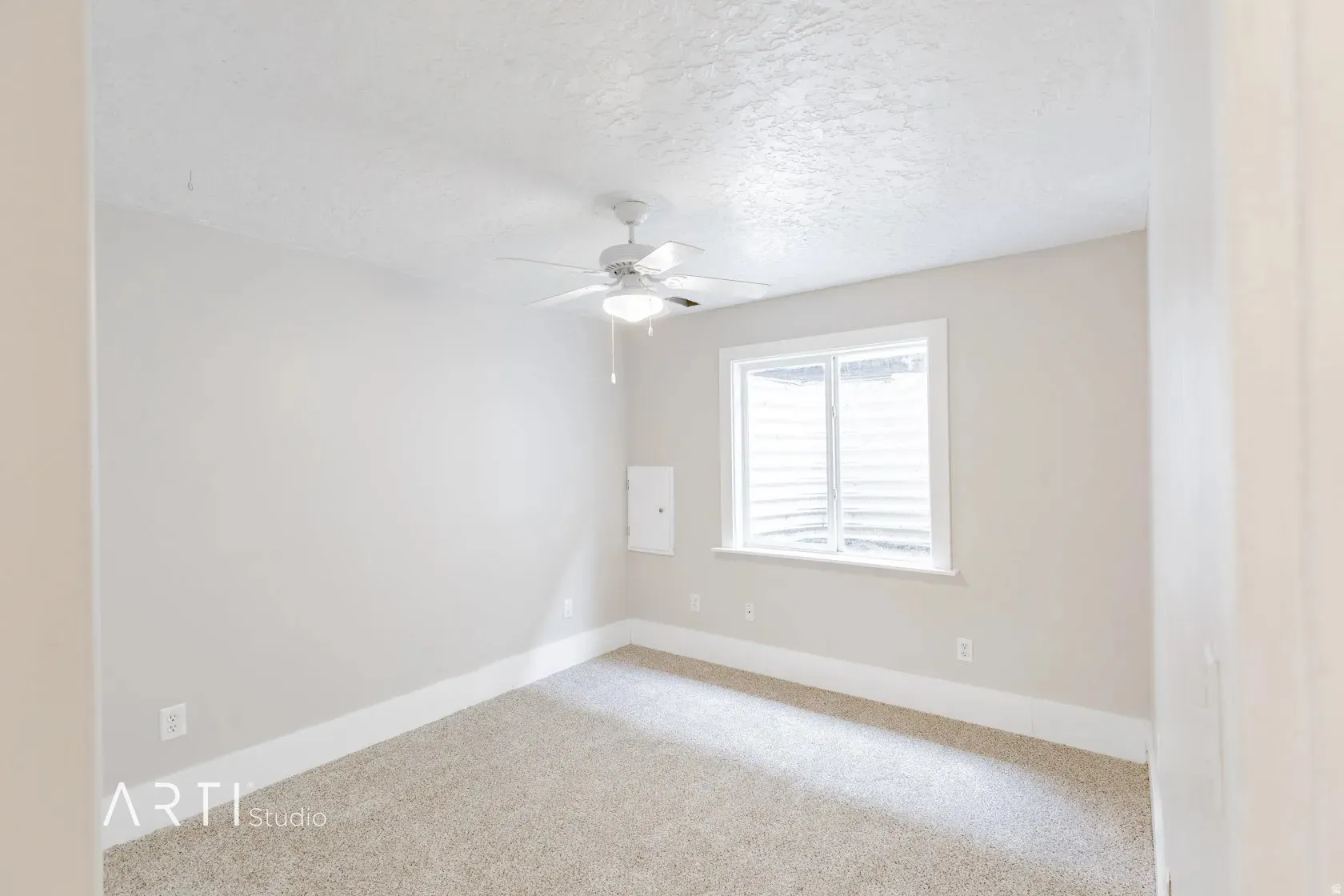 Recessed window with white trim, ceiling fan, and carpeted flooring