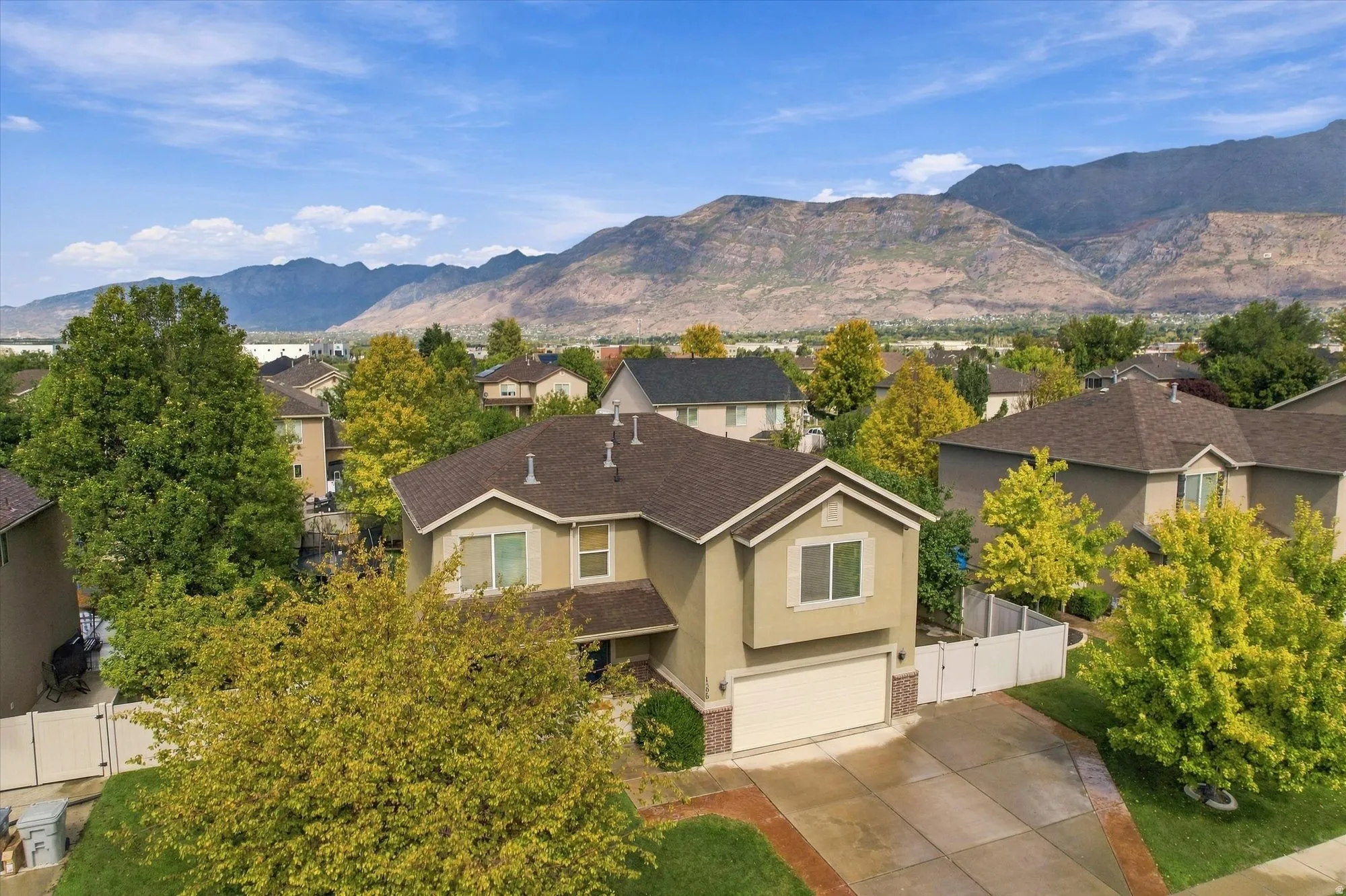 Two-story home featuring stucco siding, an attached garage, and a concrete driveway