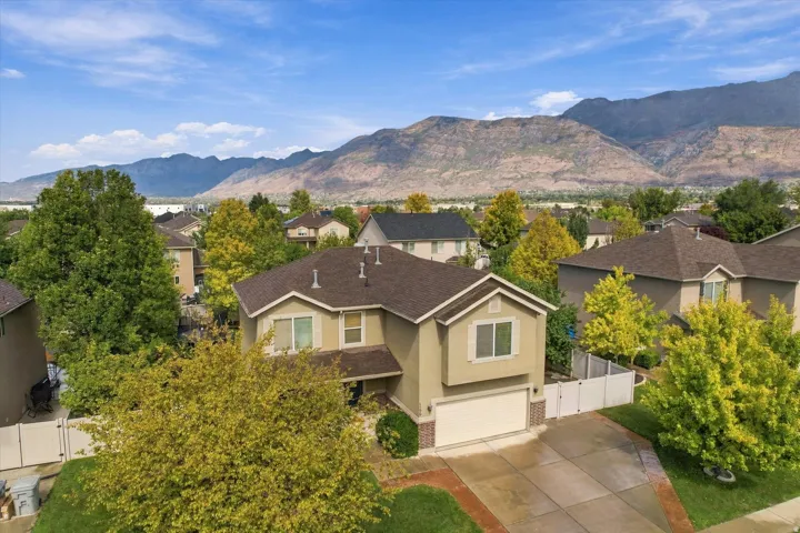Two-story home featuring stucco siding, an attached garage, and a concrete driveway