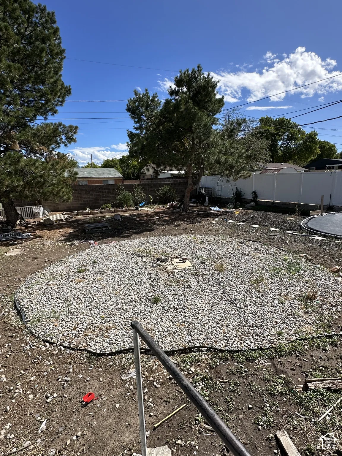 Backyard featuring a gravel patio area and mature trees