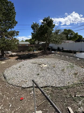 Backyard featuring a gravel patio area and mature trees