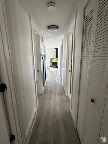 Wood-finish flooring throughout, bright overhead lighting, and louvered bifold closet doors