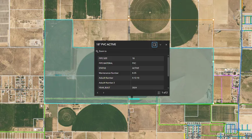 GIS Map Overlay. Displaying property boundaries with a pop-up detailing pipe infrastructure attributes including size, material, and installation year for the property