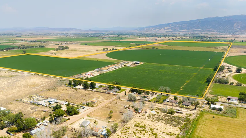 Expansive agricultural acreage featuring cultivated fields and a distant mountain range