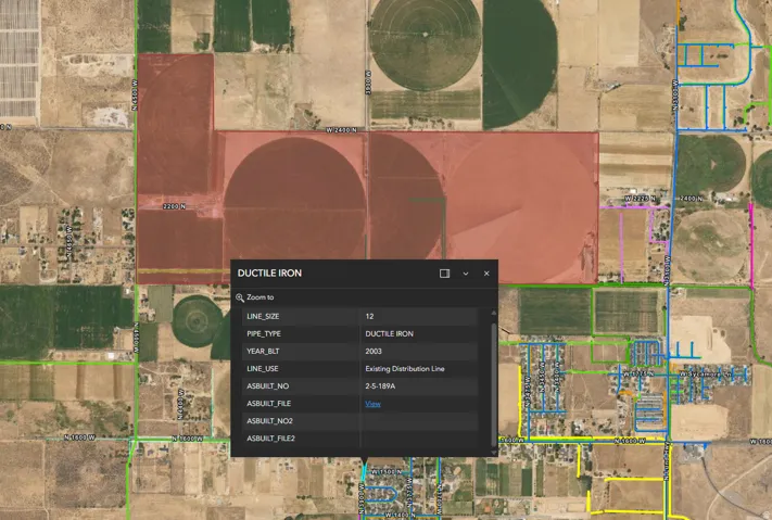 Geographic Information System Map. Displaying property boundaries and utility infrastructure data, including pipe specifications and build year