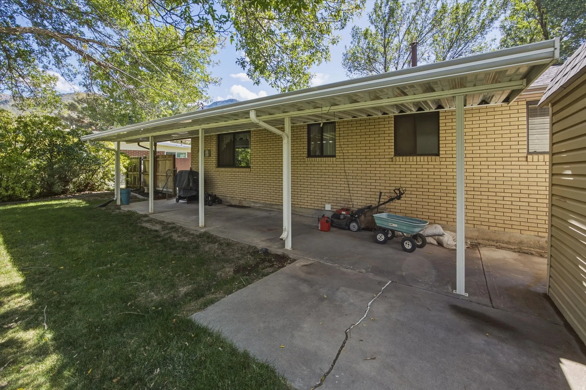Covered patio with a concrete surface and brick exterior