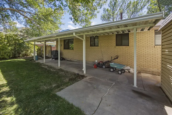 Covered patio with a concrete surface and brick exterior