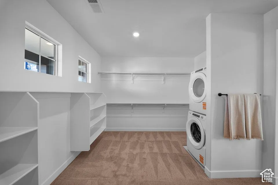 Built-in shelving units, dual windows, integrated clothes washer and dryer, and wall-mounted hanging rods