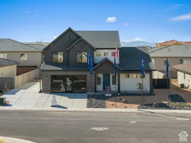 Contemporary two-story exterior with a mixed material facade featuring stone accents and vertical siding