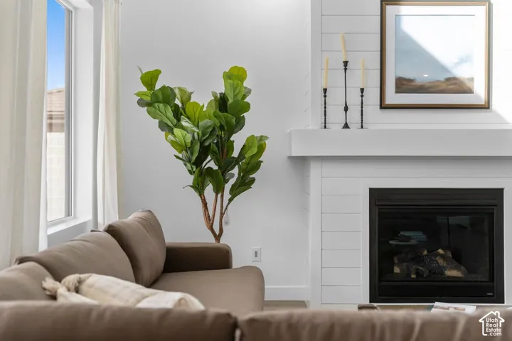 White shiplap fireplace with a black insert and a substantial mantel
