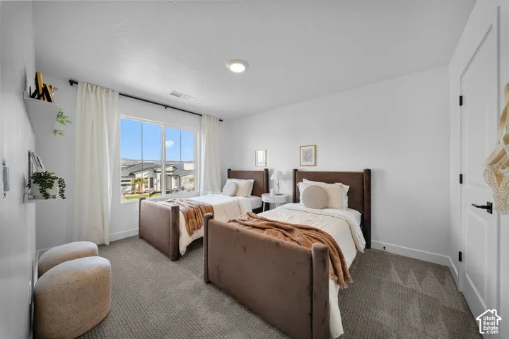 Expansive window with white trim, recessed lighting, white walls, and gray carpeting