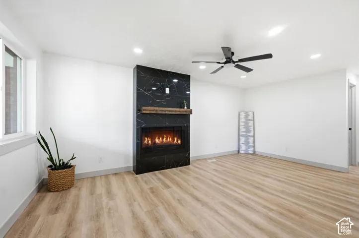 Modern fireplace with a black marbled surround and a wood-finish mantel